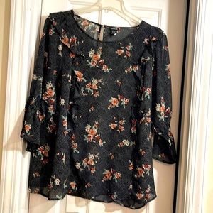 Torrid blouse. Size 3. Black sheer floral print. Button hole back.